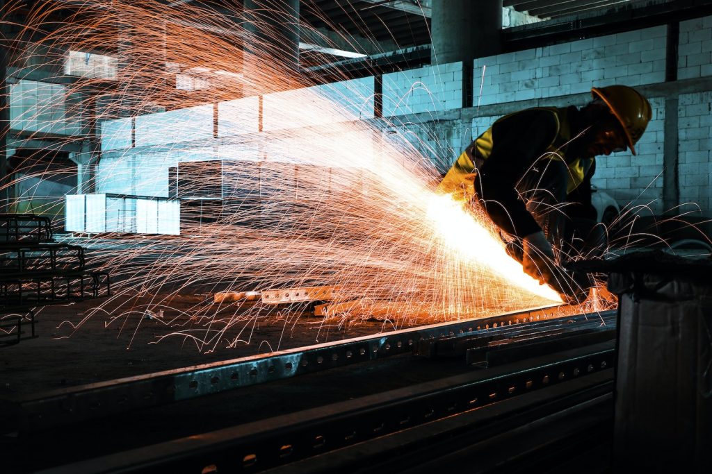 A Worker Cutting Metal